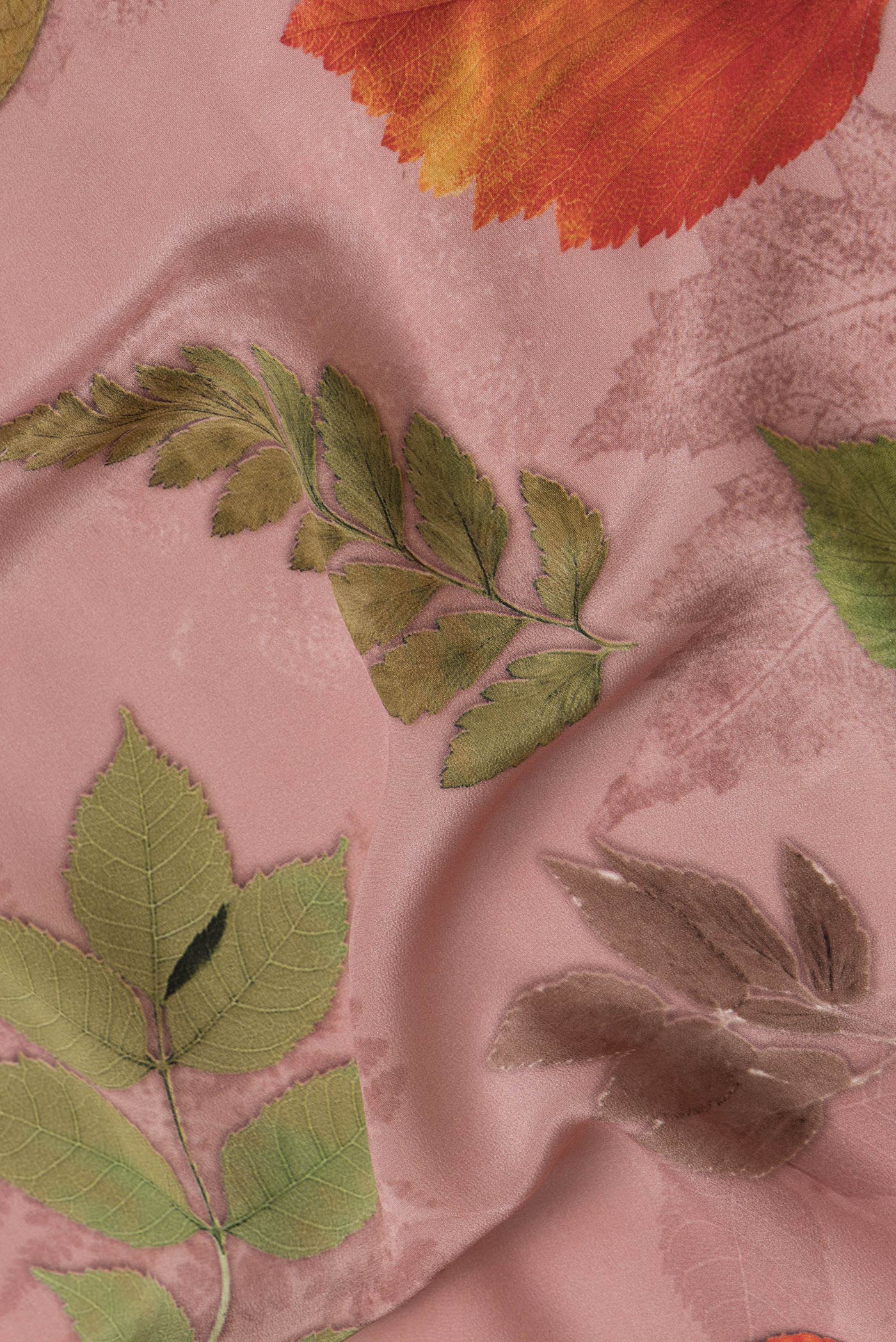 Close up of Rose Gold Dual Tone Mysore Crepe Saree with Printed design on the body and Without Border.  displaying folds