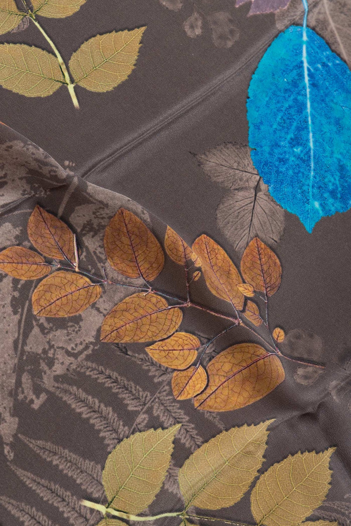 Close up of Grey Dual Tone Mysore Crepe Saree with Printed design on the body and Without Border.  displaying folds