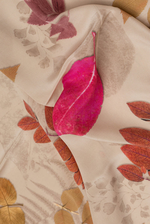 Close up of Beige Dual Tone Mysore Crepe Saree with Printed design on the body and Without Border.  displaying folds