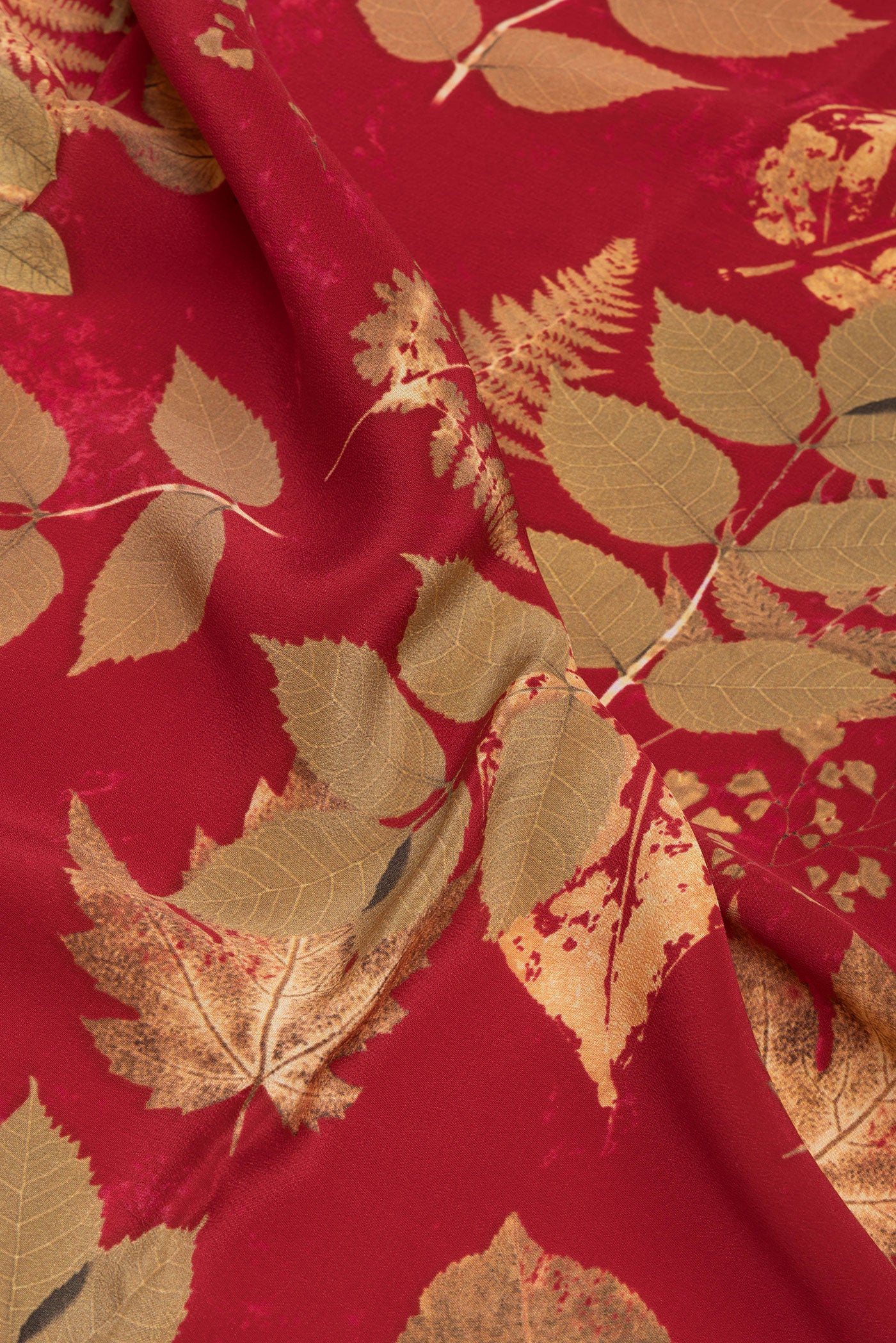 Close up of Maroon Crepe Saree with Printed design on the body and Without Border.  displaying folds
