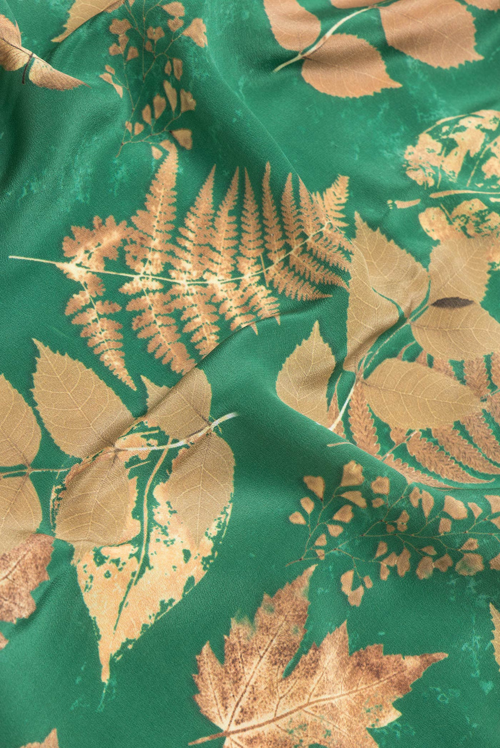 Close up of Green Dual Tone Crepe Saree with Printed design on the body and Without Border.  displaying folds
