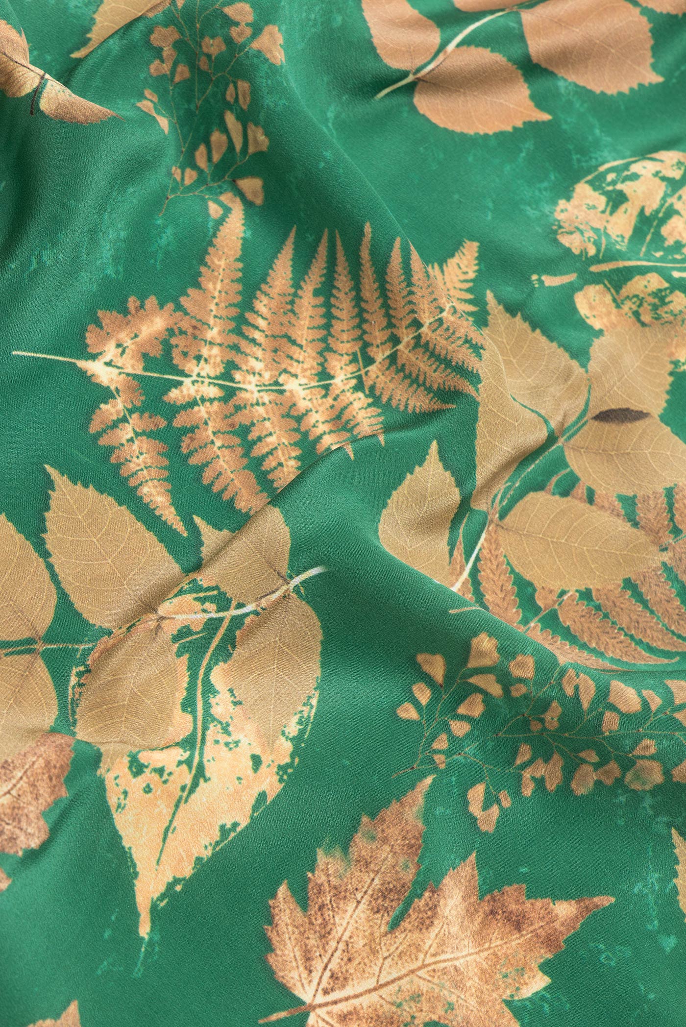 Close up of Green Dual Tone Crepe Saree with Printed design on the body and Without Border.  displaying folds