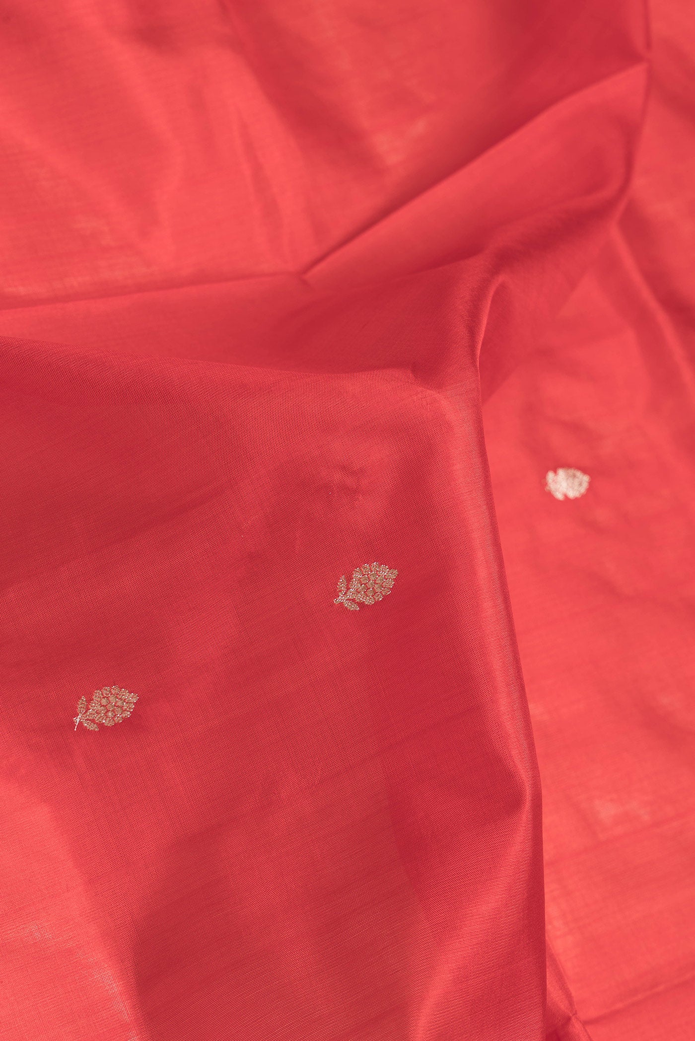 Close up of Red Dual Tone Banarasi Silk Saree with Zari Butta on the body and Zari Border.  displaying folds