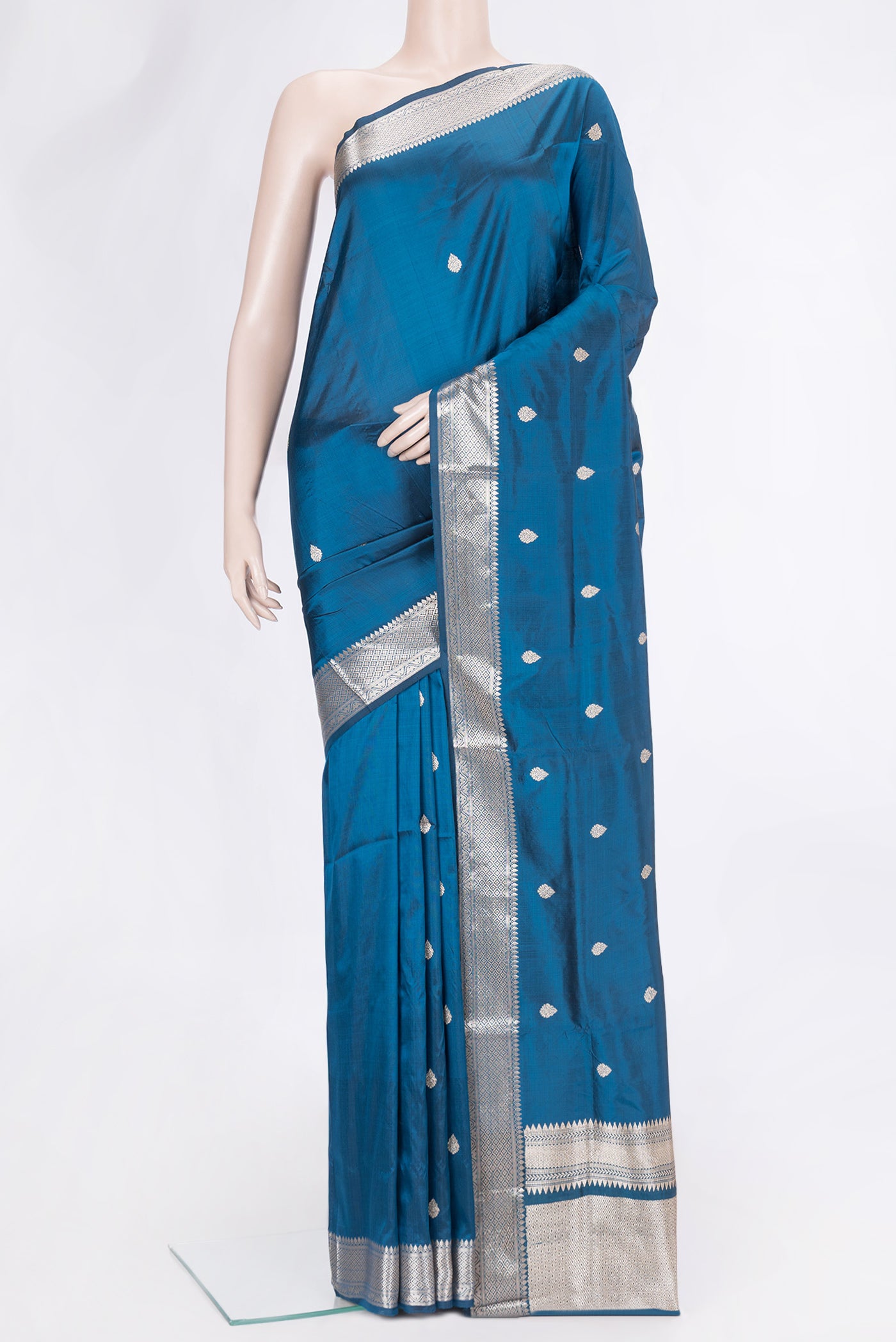 Peacock Blue Dual Tone Banarasi Silk Saree with Zari Butta on the body and Zari Border.  displayed on a mannequin