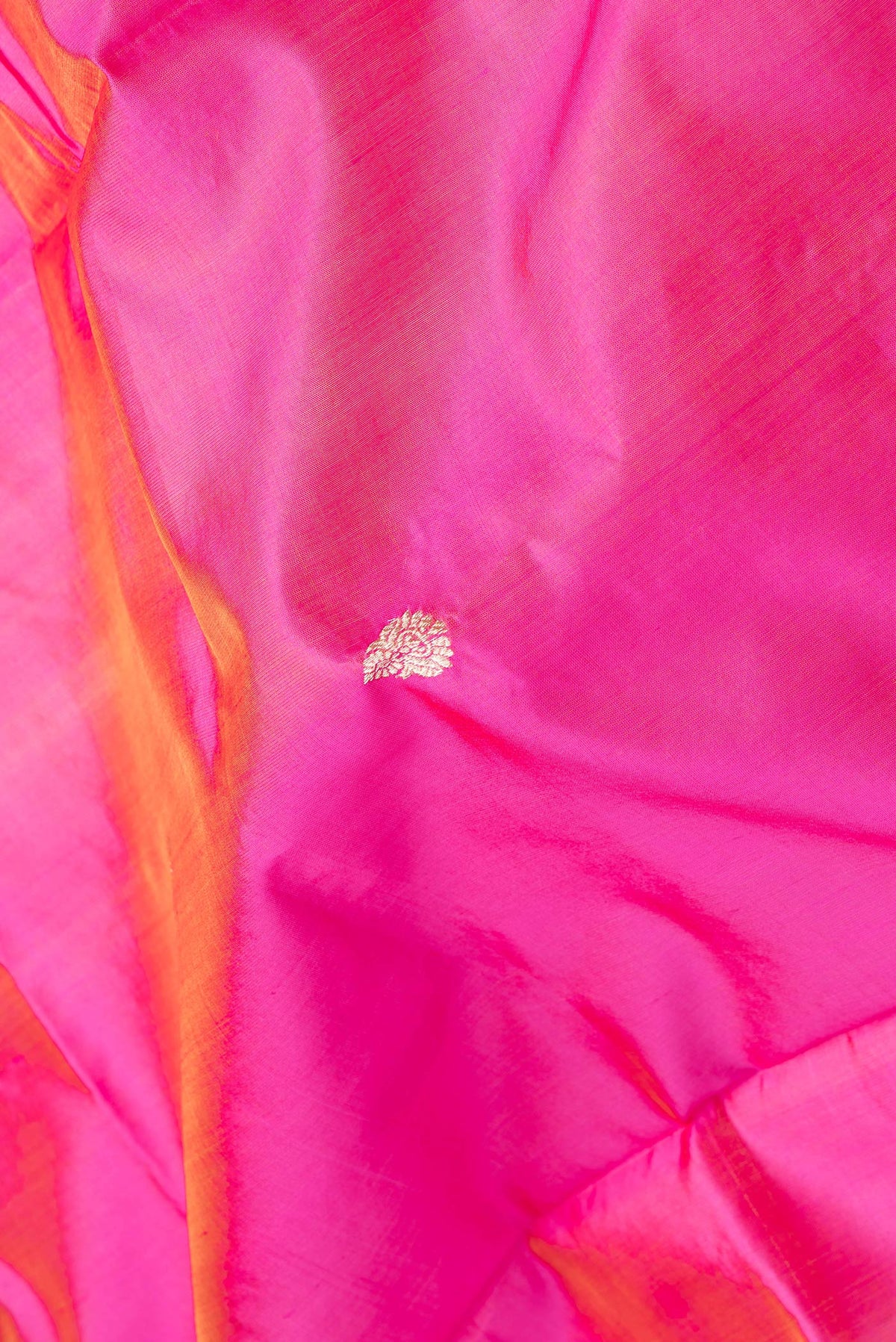 Close up of Pink Dual Tone Banarasi Silk Saree with Zari Butta on the body and Zari Border.  displaying folds