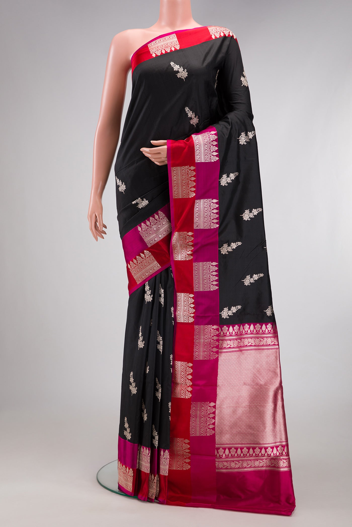Black Banarasi Katan Silk Saree with Zari Butta on the body and Fancy Border.  displayed on a mannequin