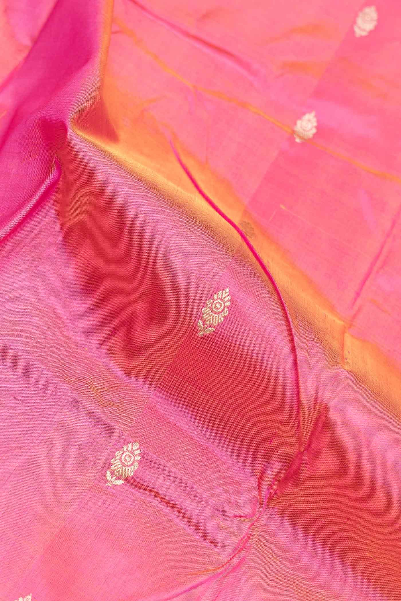 Close up of Pink Dual Tone Banarasi Silk Saree with Zari Butta on the body and Zari And Thread Border.  displaying folds
