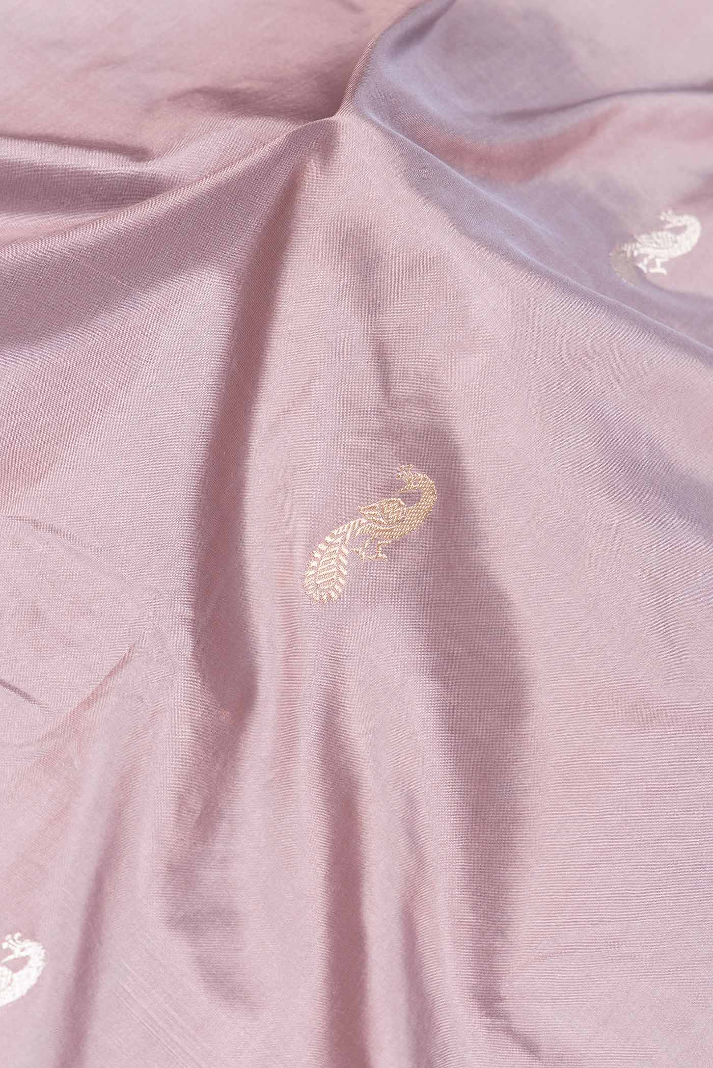 Close up of Rose Gold Dual Tone Banarasi Silk Saree with Zari Butta on the body and Zari Border.  displaying folds