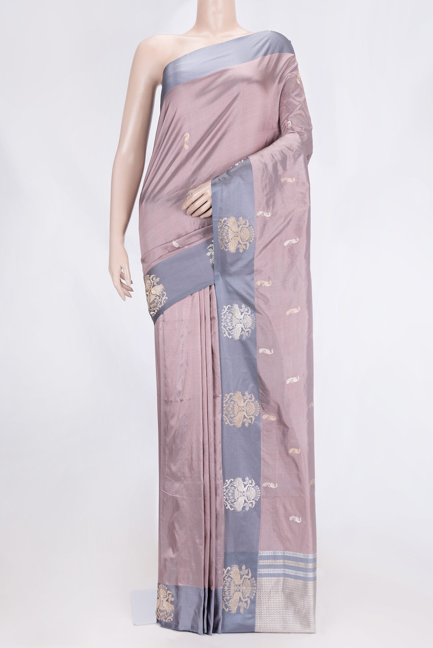 Rose Gold Dual Tone Banarasi Silk Saree with Zari Butta on the body and Zari Border.  displayed on a mannequin