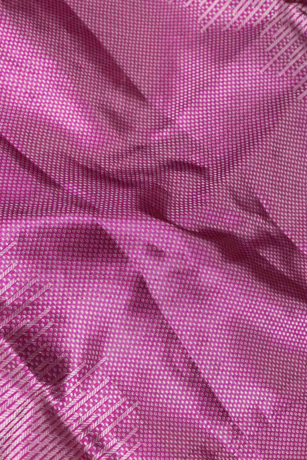 Close up of Magenta Dual Tone Banarasi Saree with Zari Brocade on the body and Zari Border displaying folds