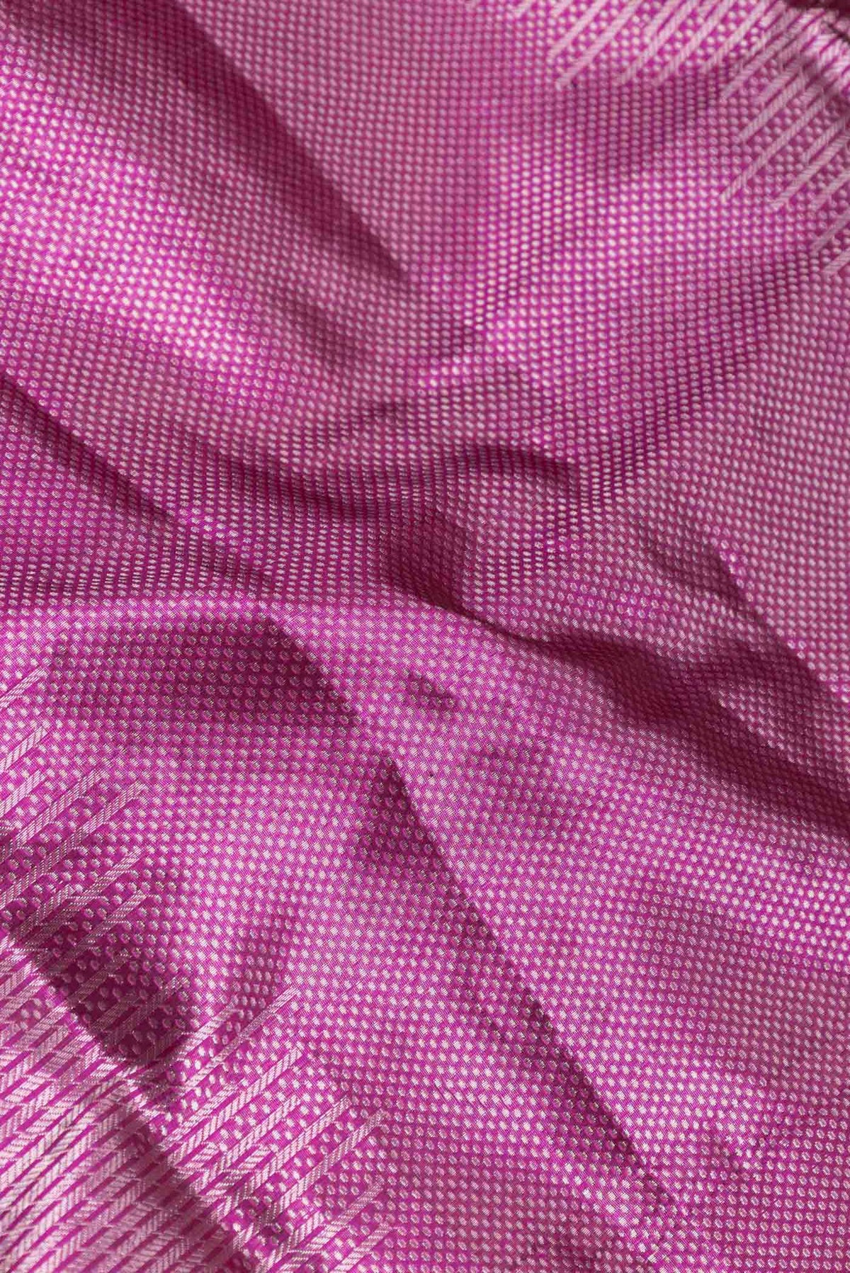 Close up of Magenta Dual Tone Banarasi Saree with Zari Brocade on the body and Zari Border displaying folds