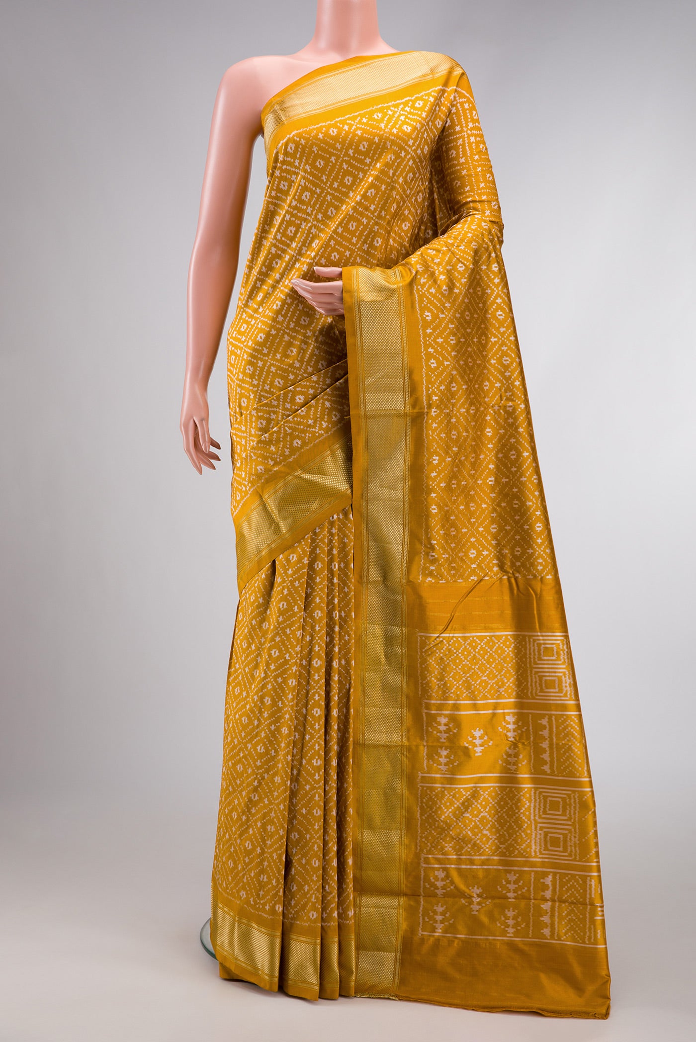 Mustard Dual Tone Double Ikat Nine Yards Saree with Ikat Print on the body and Zari Border.  displayed on a mannequin