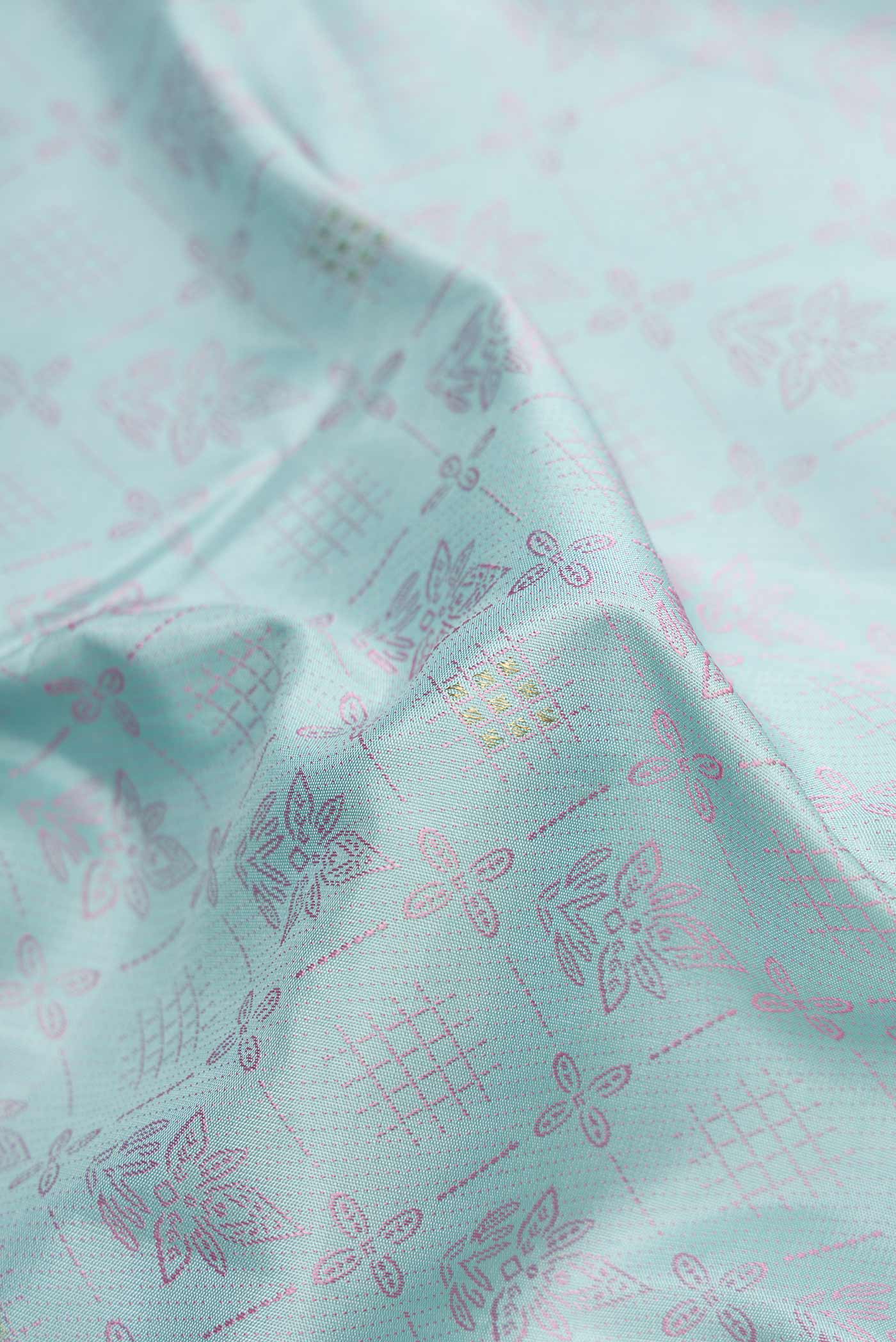 Close up of Pure Silk Pure Zari Light Blue Dual Tone Kanchipuram Saree with Jacquard design on the body and Fancy Border displaying folds