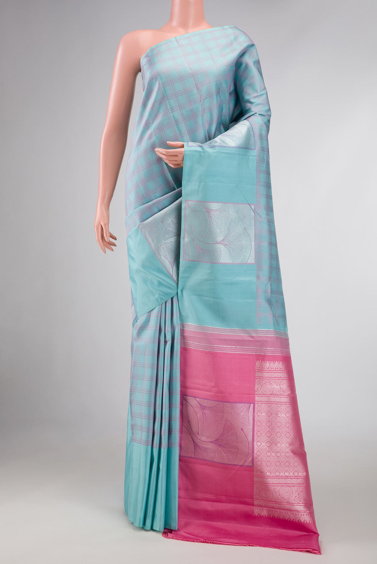 Sky Blue Dual Tone Kanchipuram Silk Saree with Checked design on the body and Fancy Border displayed on a mannequin