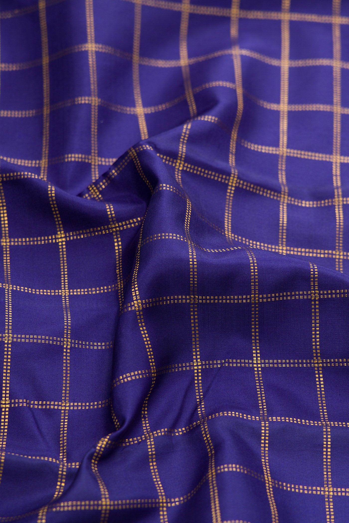 Close up of Navy Blue Kanjivaram Silk Saree with Checked design on the body and Zari Border.  displaying folds
