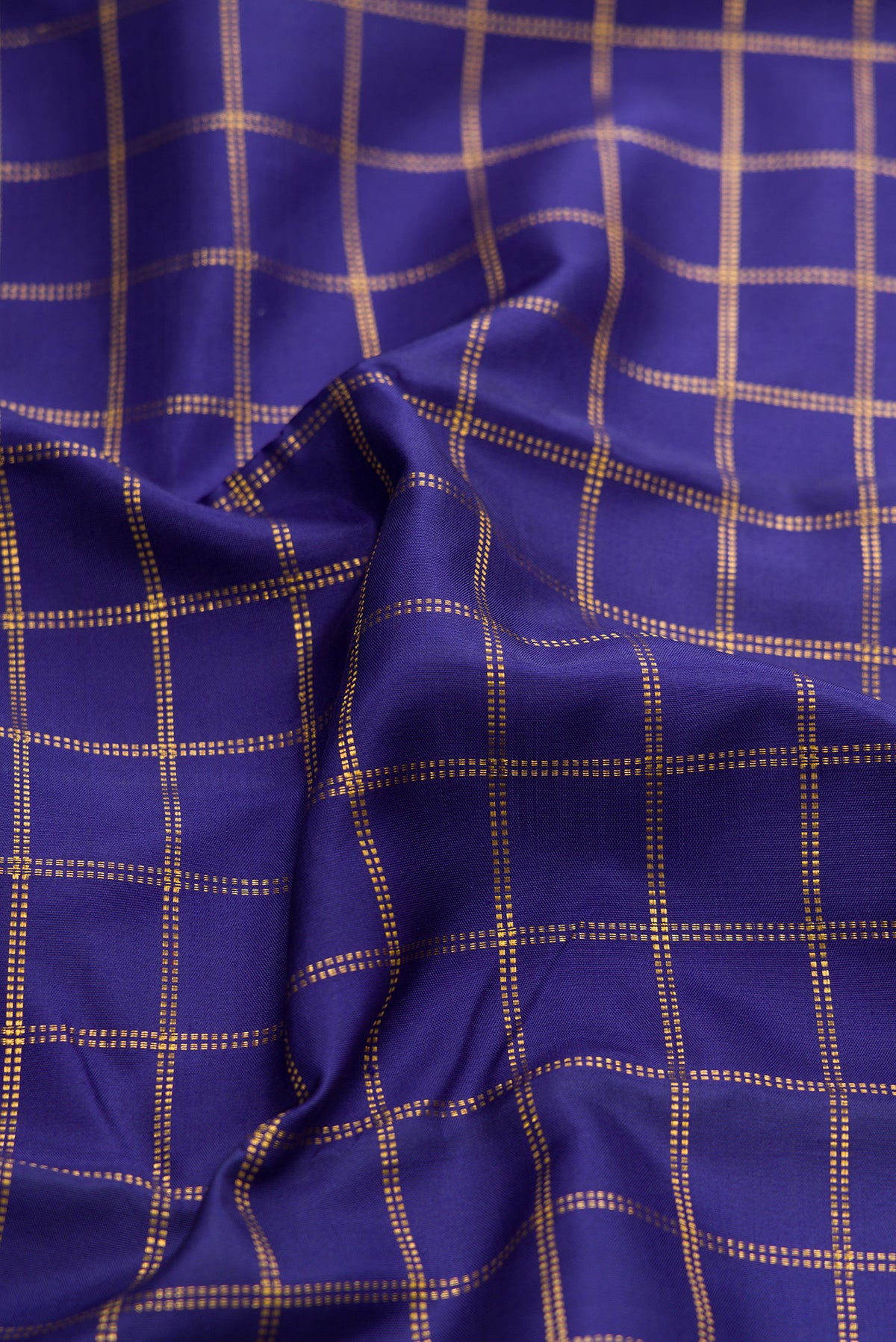 Close up of Navy Blue Kanjivaram Silk Saree with Checked design on the body and Zari Border.  displaying folds