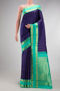 Navy Blue Kanjivaram Silk Saree with Checked design on the body and Zari Border.  displayed on a mannequin