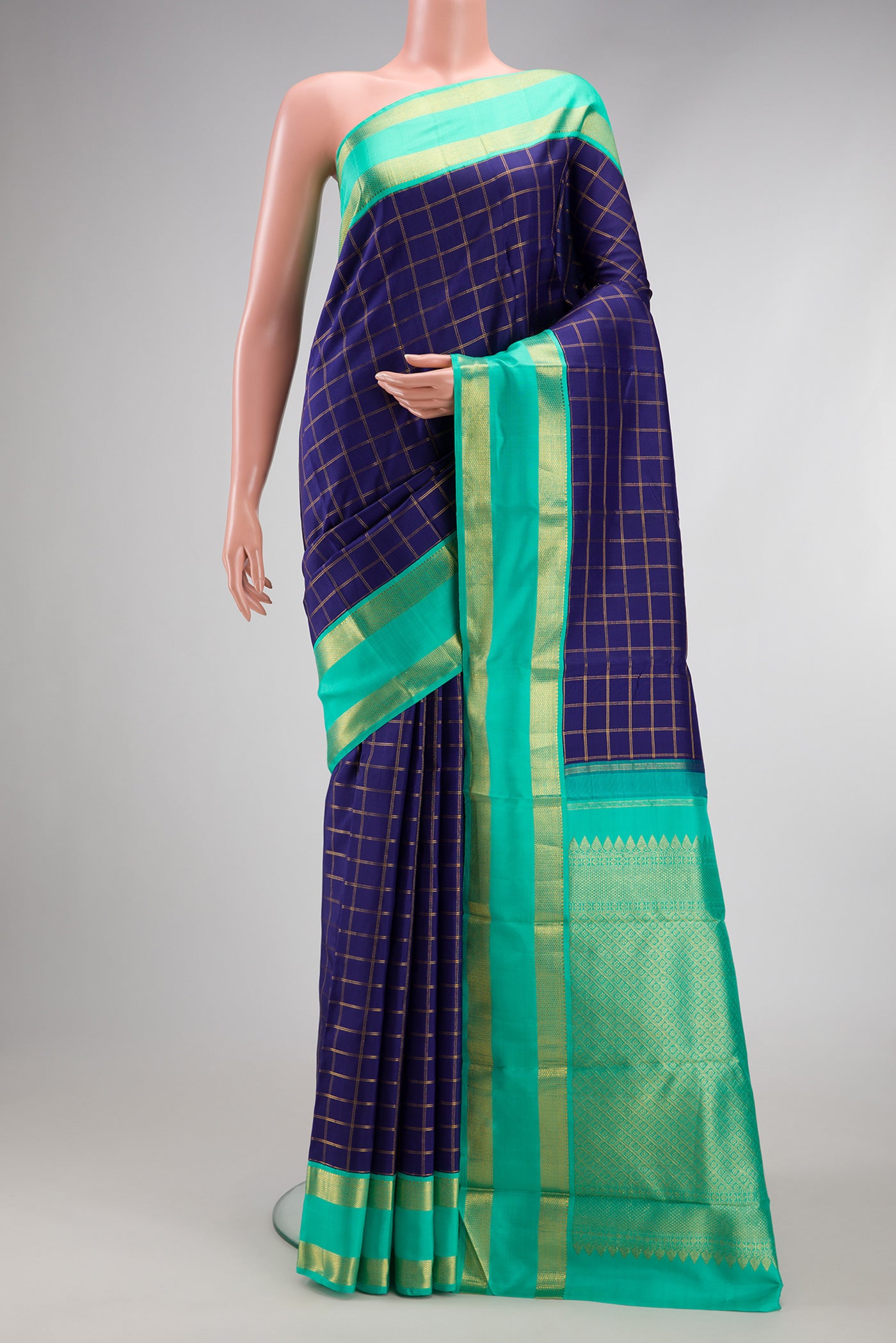 Navy Blue Kanjivaram Silk Saree with Checked design on the body and Zari Border.  displayed on a mannequin