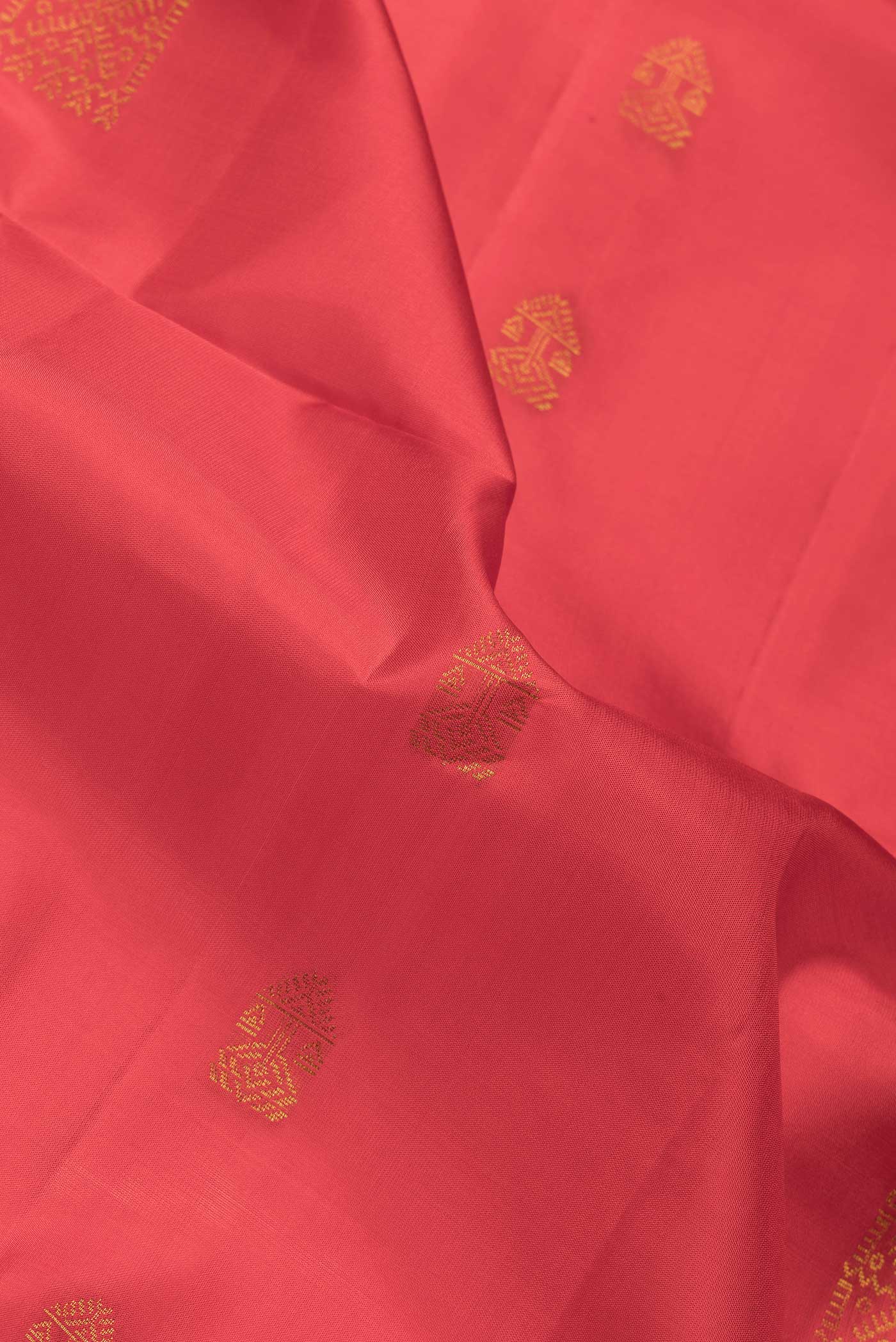 Close up of Red Dual Tone Soft Silk Saree with Zari Butta on the body and Zari Border.  displaying folds