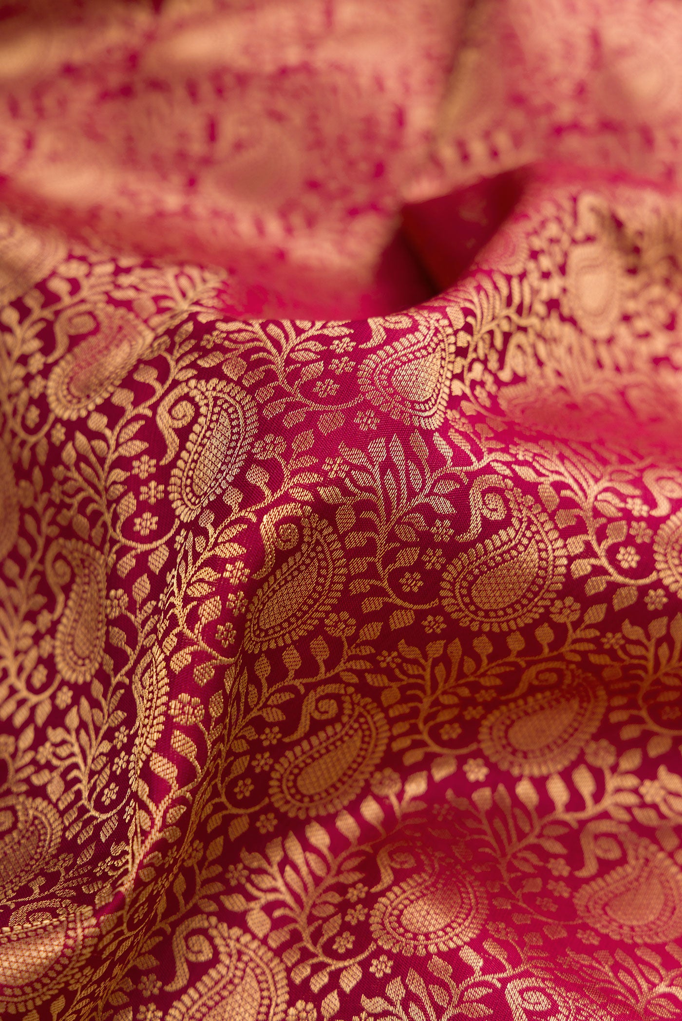 Close up of Maroon Dual Tone Kanjivaram Silk Saree with Zari Brocade on the body and Zari Border.  displaying folds