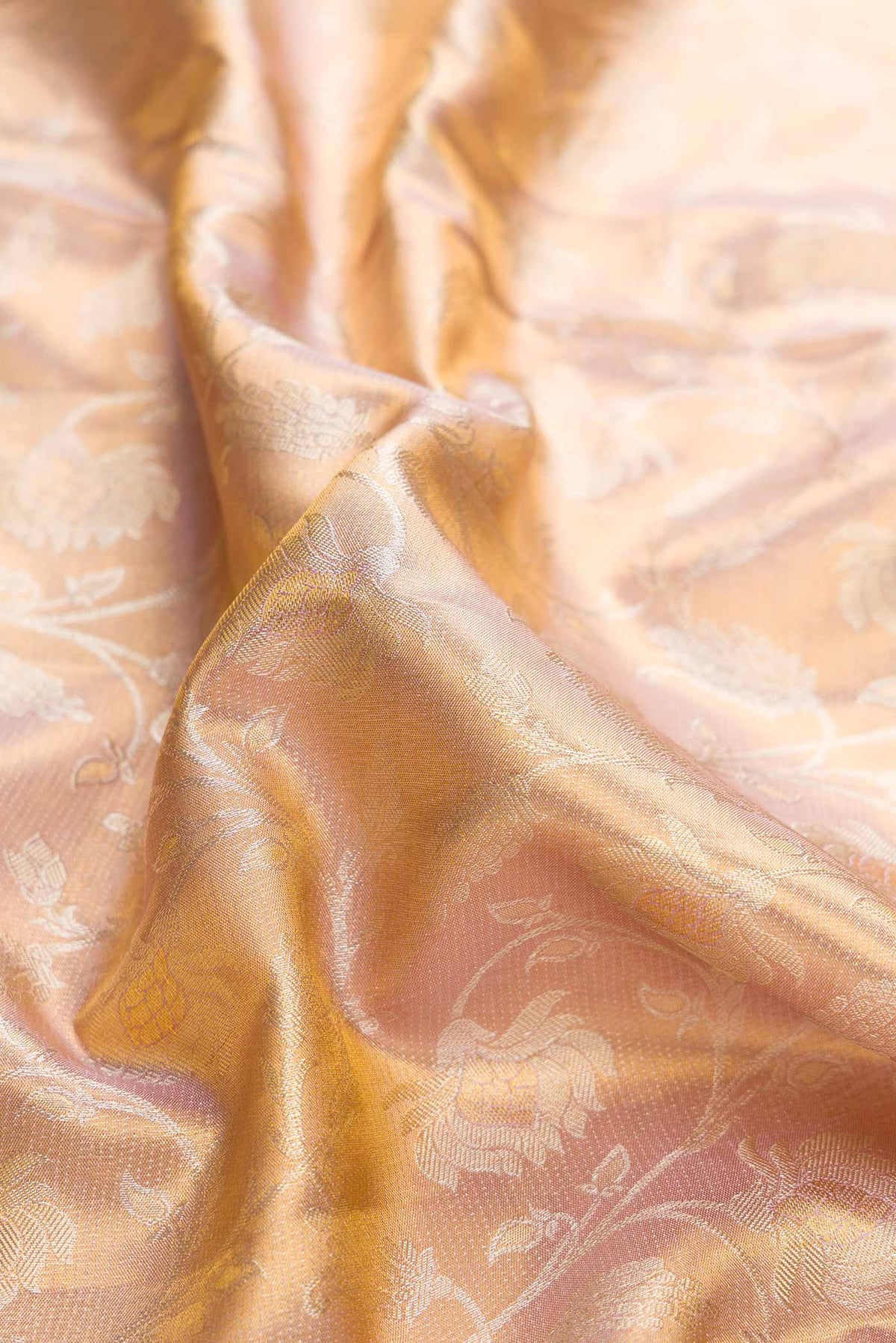 Close up of Sandel with Gold Color Kanchipuram Tissue Silk Saree with Zari Brocade on the body and Zari Border displaying folds