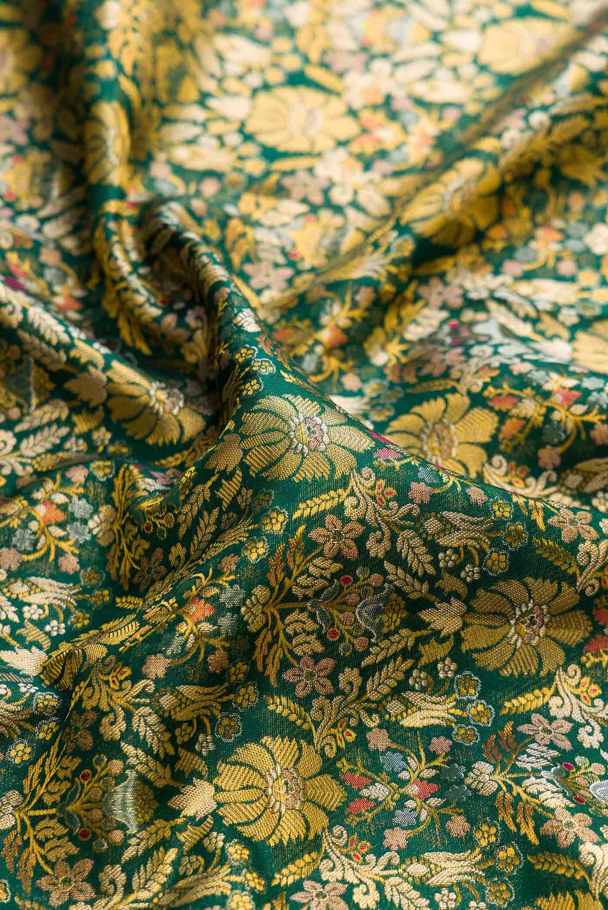 Close up of Green Dual Tone Kanchipuram Tissue Silk Saree with Zari Brocade on the body and Zari Border displaying folds