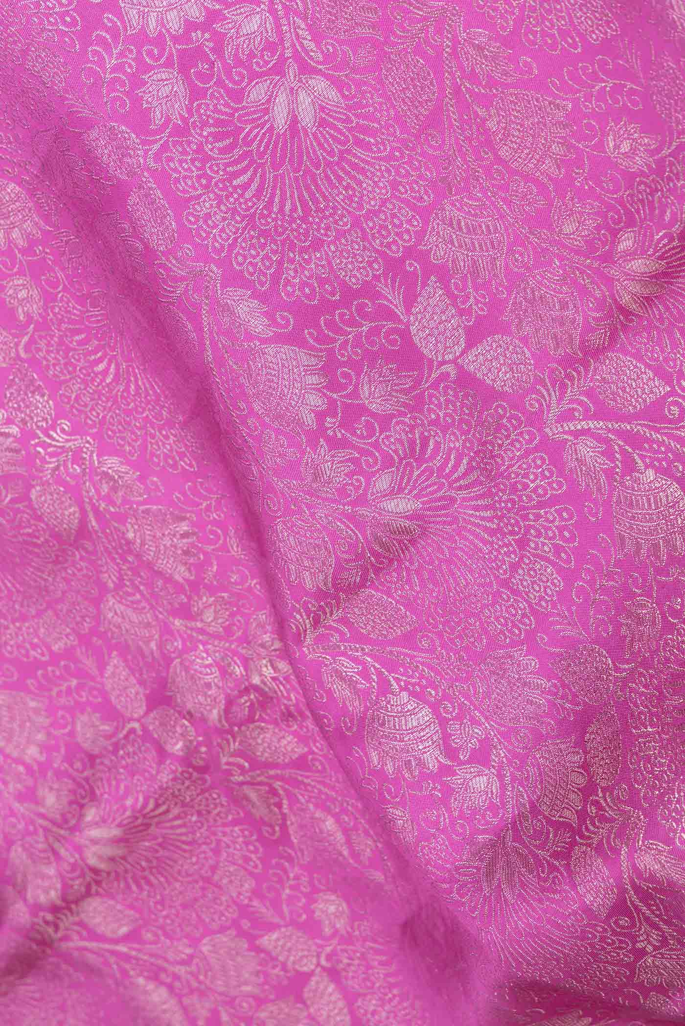 Close up of Magenta Dual Tone Kanchipuram Saree with Zari Brocade on the body and Zari Border displaying folds