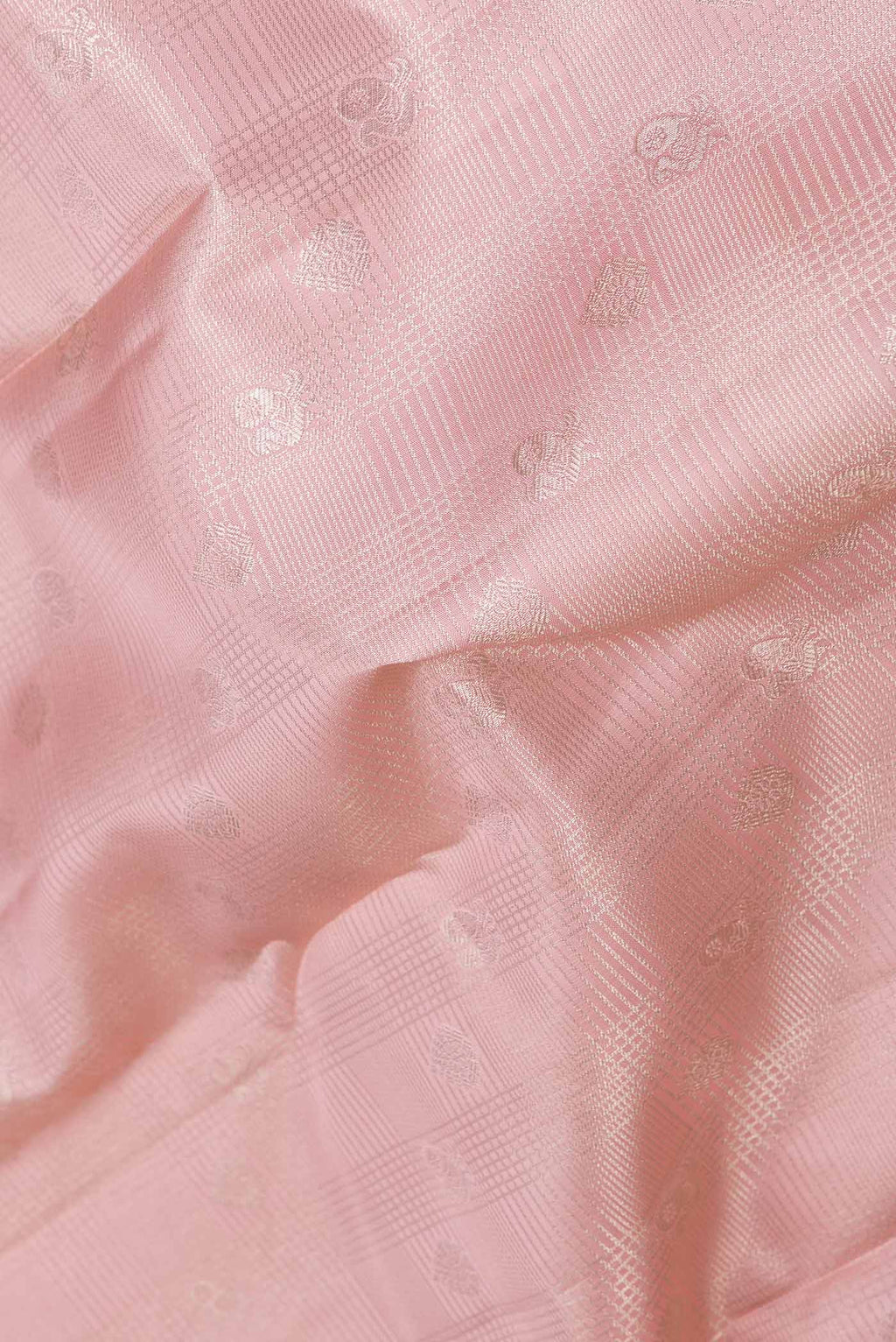 Close up of Golden Peach Dual Tone Kanchipuram Saree with Zari Brocade on the body and Zari Border displaying folds