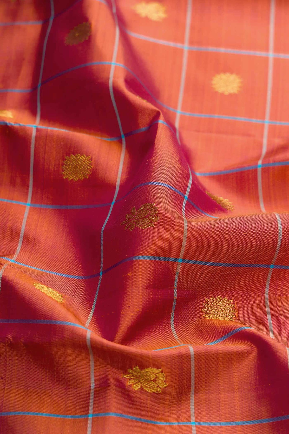 Close up of Maroon Dual Tone Kanchipuram Silk Saree with Checked design on the body and Zari Border displaying folds