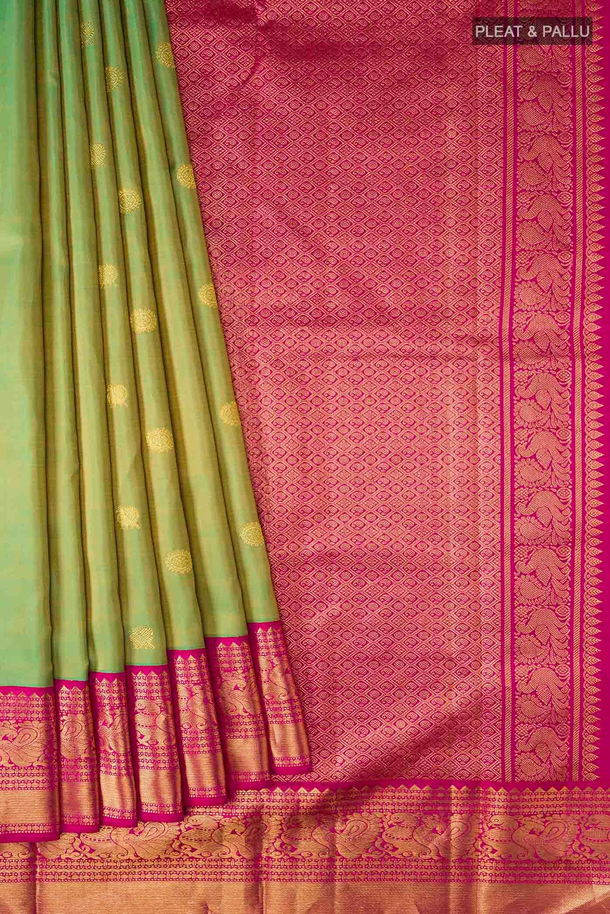 Pleats and pallu of Green Kanchipuram Silk Saree with Zari Butta on the body and Zari Border