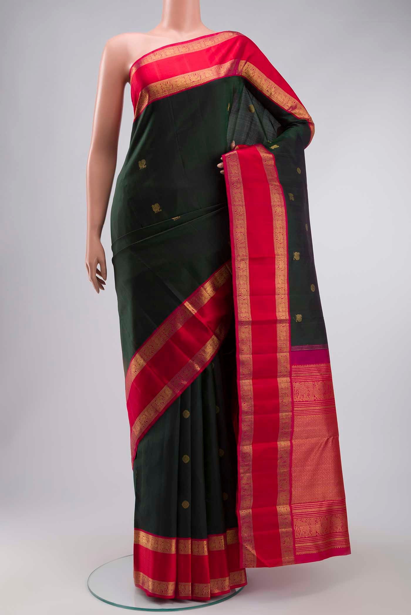 Green Kanchipuram Silk Saree with Zari Butta on the body and Zari Border displayed on a mannequin