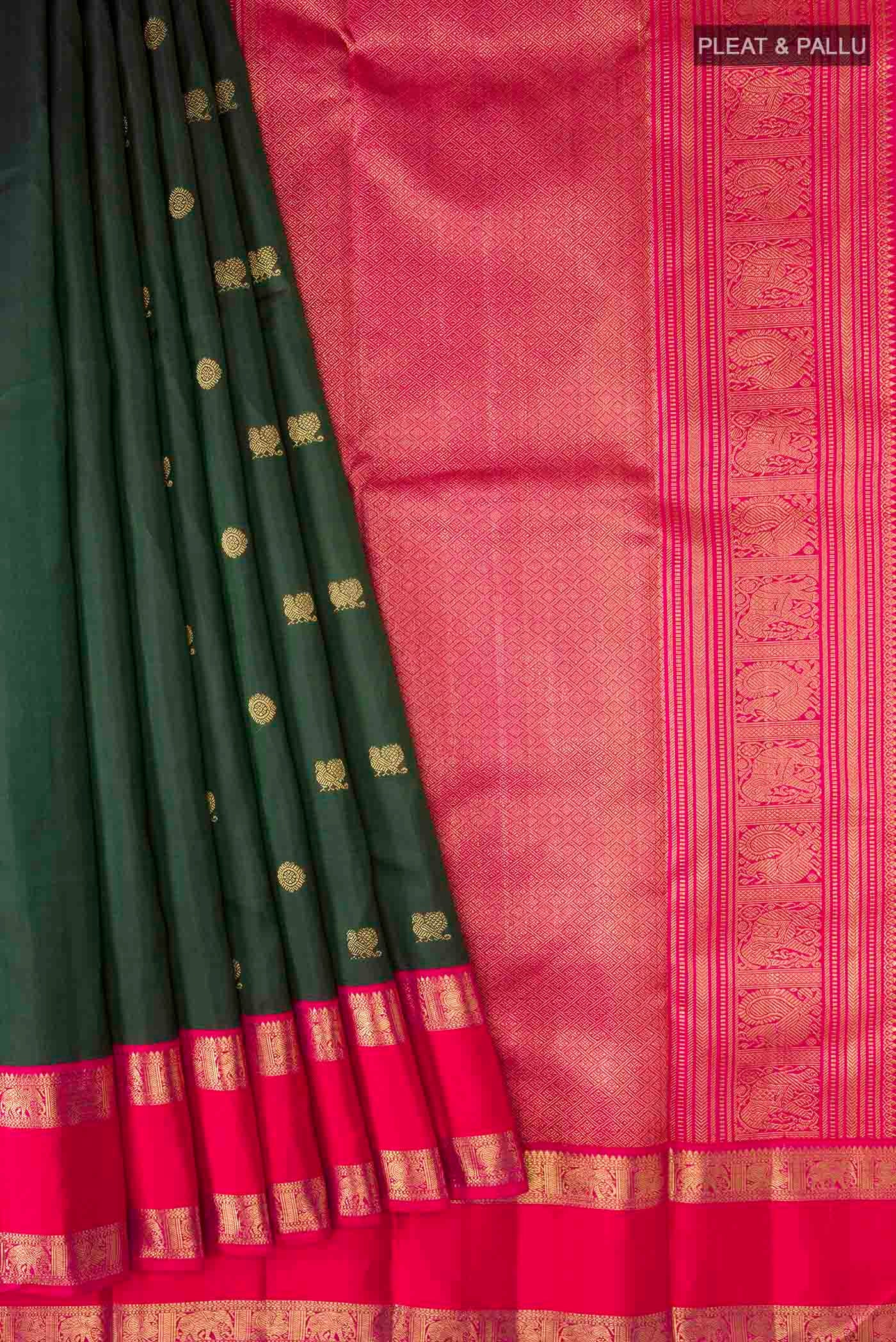 Pleats and pallu of Green Kanchipuram Silk Saree with Zari Butta on the body and Zari Border