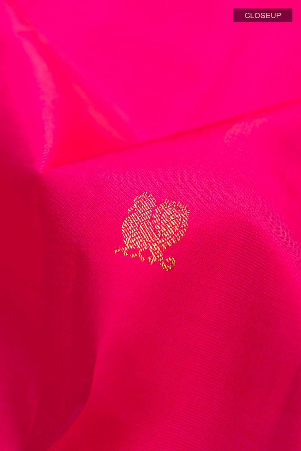 Close up of Pink Kanchipuram Silk Saree with Zari Butta on the body and Zari Border displaying folds