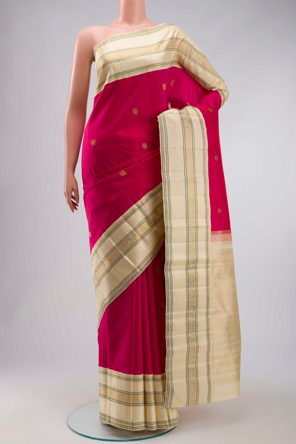 Pink Kanchipuram Silk Saree with Zari Butta on the body and Zari Border displayed on a mannequin