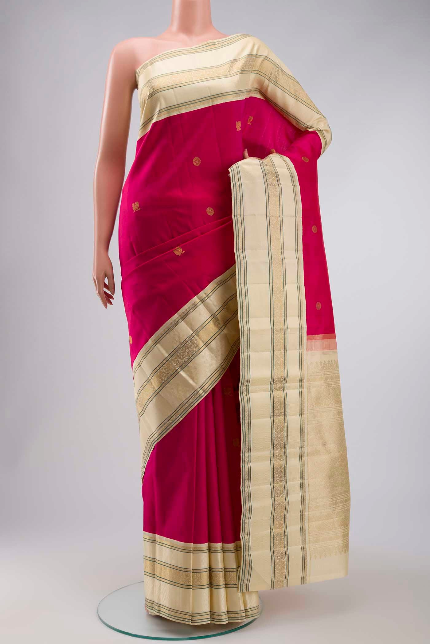 Pink Kanchipuram Silk Saree with Zari Butta on the body and Zari Border displayed on a mannequin