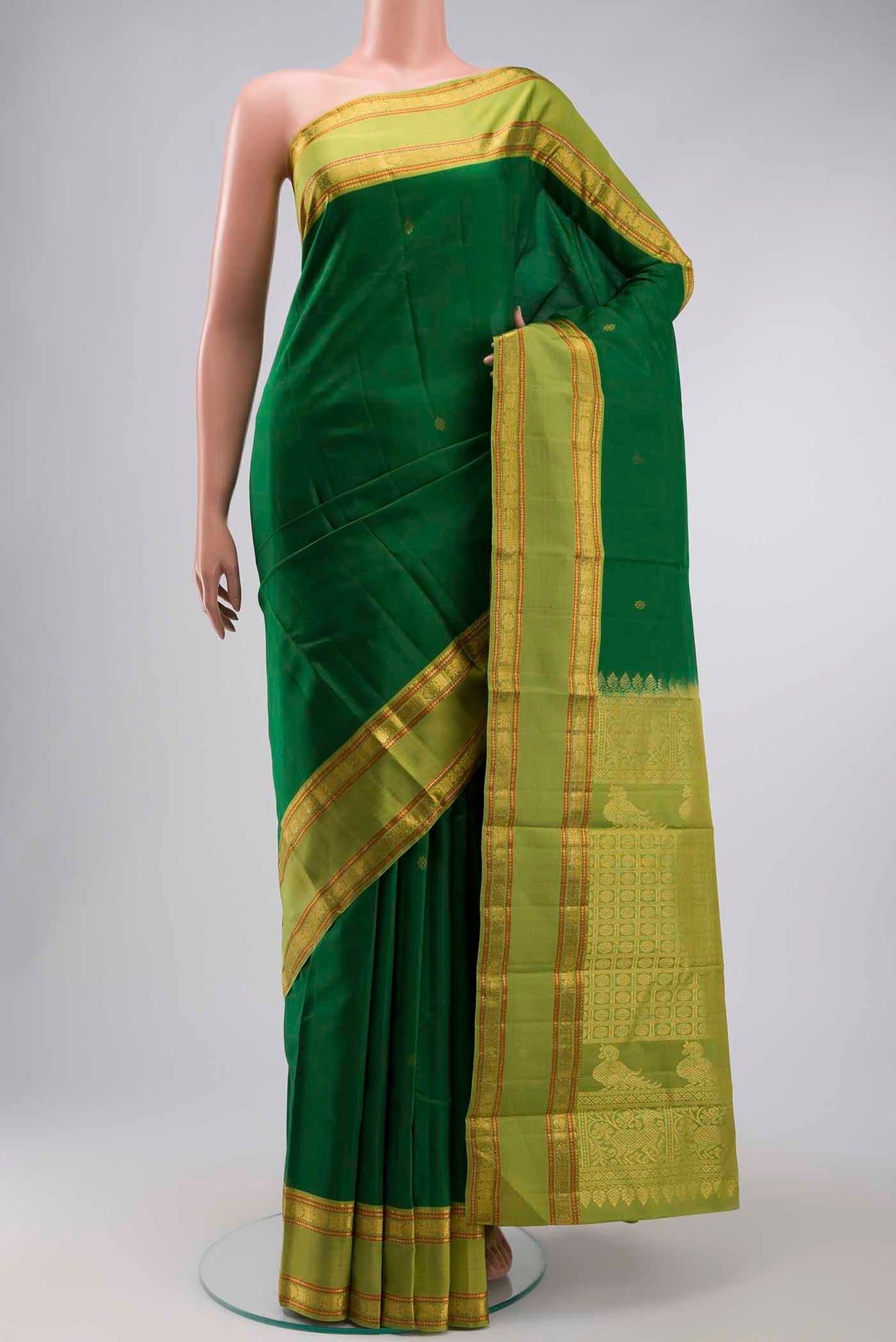 Green Kanchipuram Silk Saree with Zari Butta on the body and Zari Border displayed on a mannequin