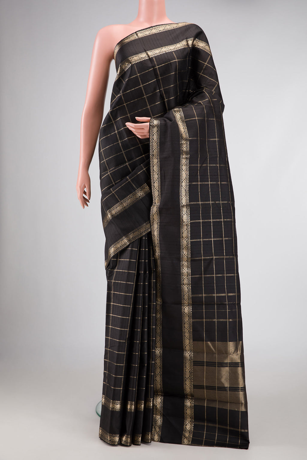 Black Dual Tone Kanchipuram Silk Saree with Checked design on the body and Zari Border displayed on a mannequin