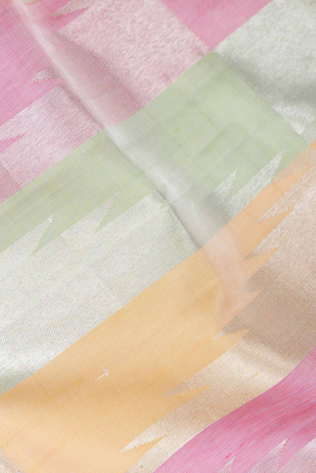 Close up of Pista Green,Pink and Sandal Color Kanchipuram Silk Saree with Zari Butta on the body and Without Border displaying folds