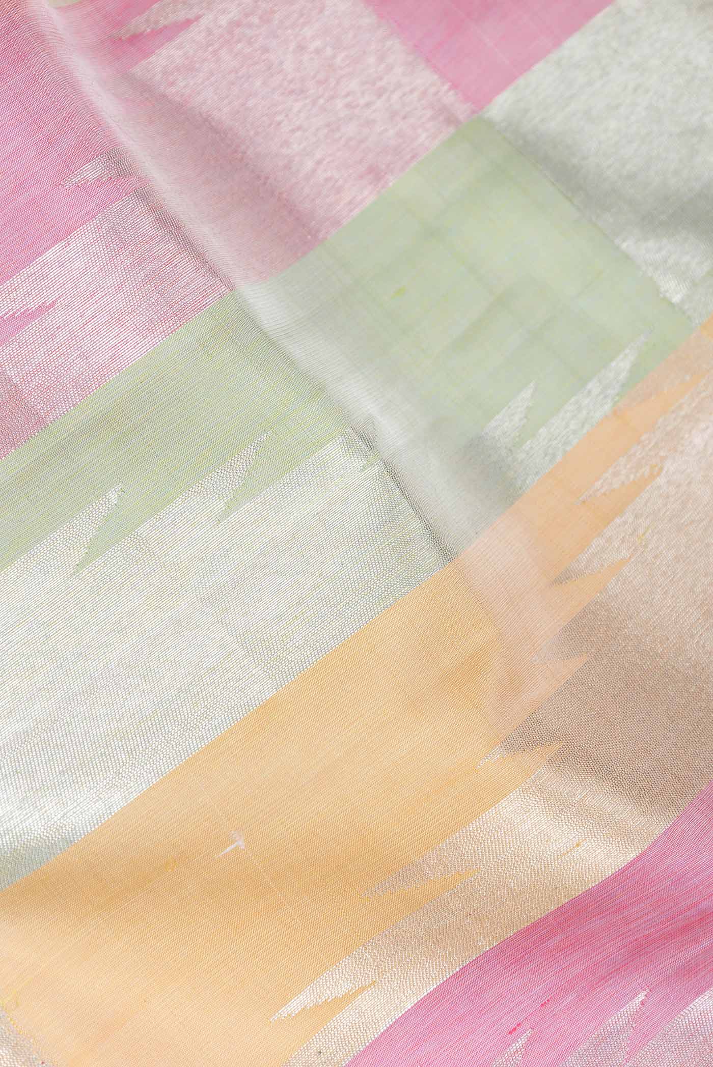 Close up of Pista Green,Pink and Sandal Color Kanchipuram Silk Saree with Zari Butta on the body and Without Border displaying folds