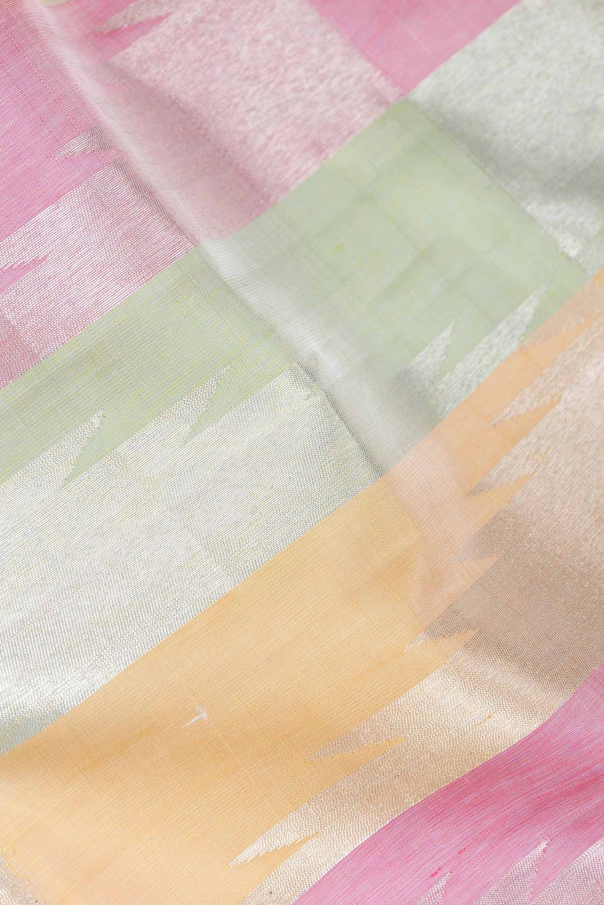 Close up of Pista Green,Pink and Sandal Color Kanchipuram Silk Saree with Zari Butta on the body and Without Border displaying folds