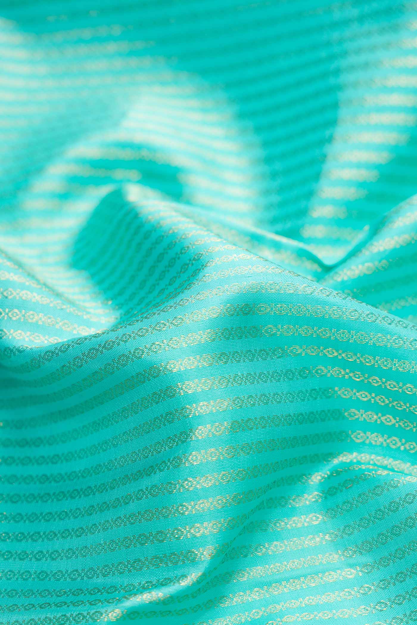 Close up of Sea Green Dual Tone Kanchipuram Silk Saree with Zari Brocade on the body and Zari Border.  displaying folds