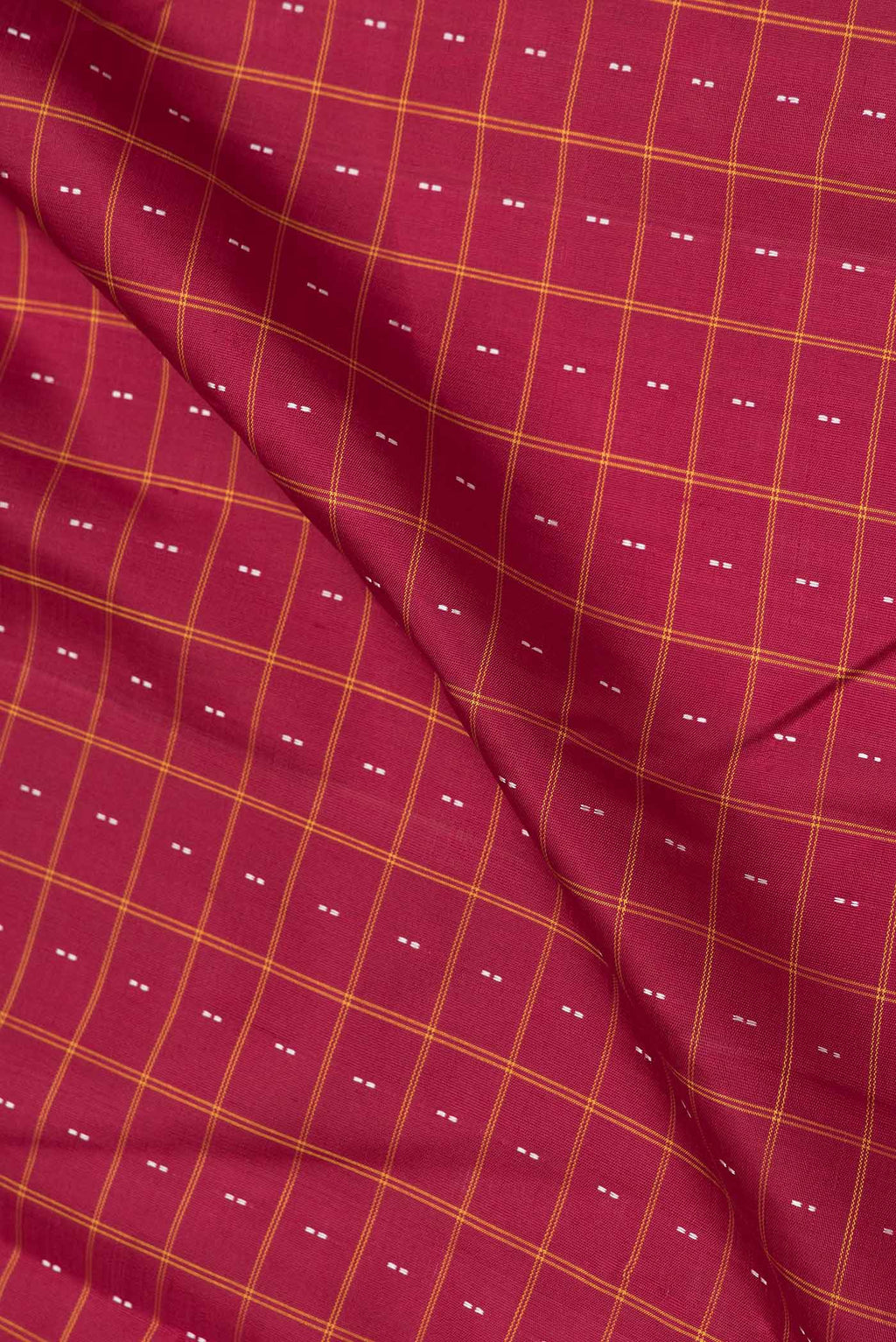 Close up of Maroon Dual Tone Kanchipuram Saree with Checked design on the body and Thread Border.  displaying folds