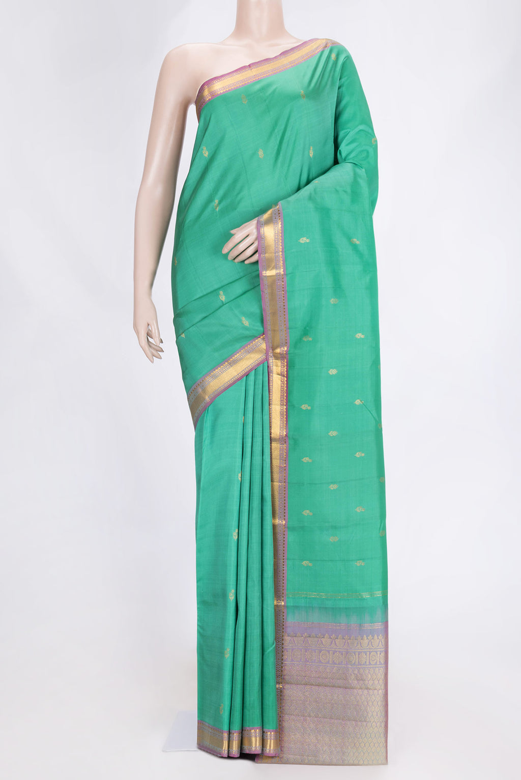 Green Dual Tone Kanchipuram Saree with Zari Butta on the body and Zari Border.  displayed on a mannequin