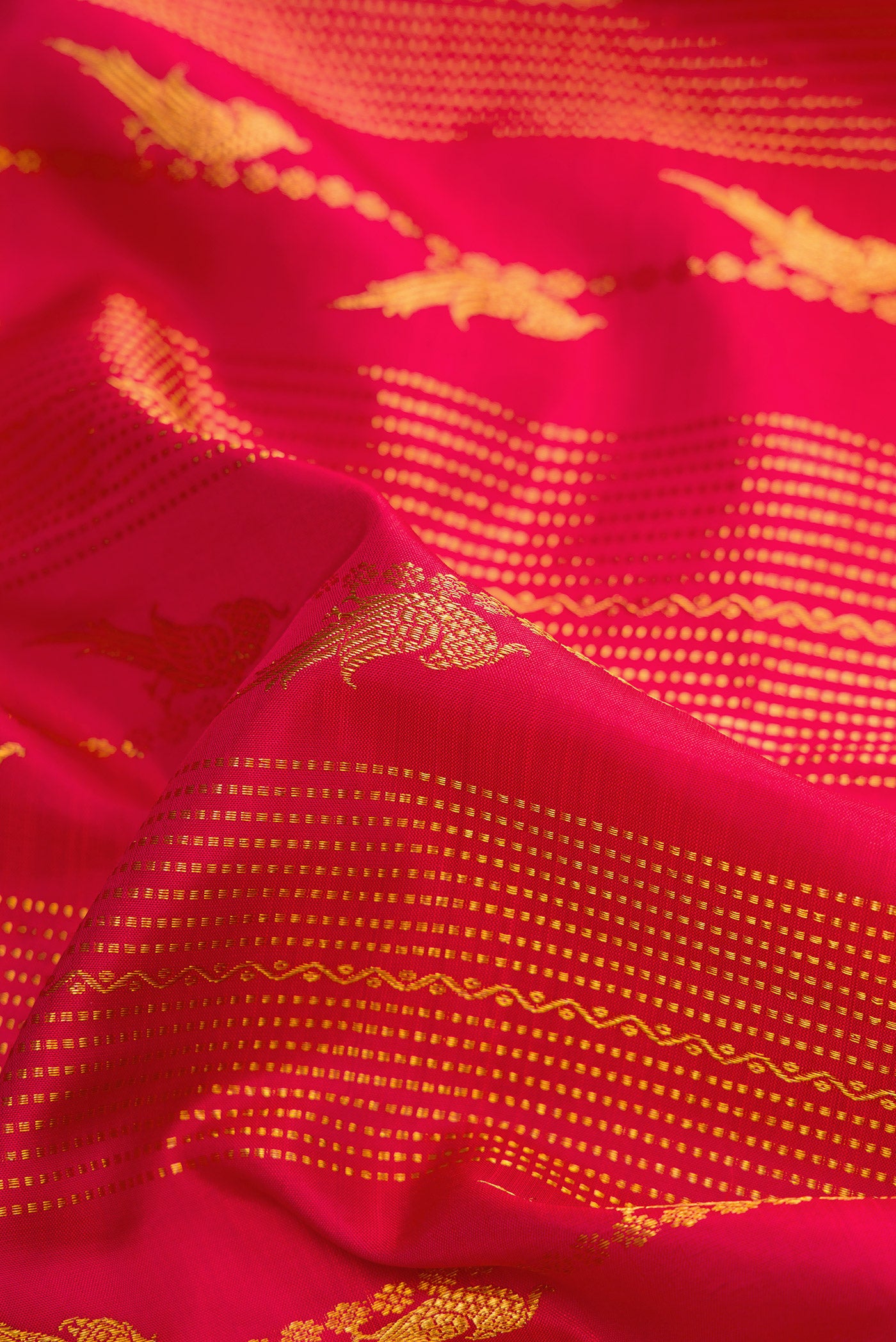 Close up of Dark Pink Dual Tone Kanjivaram Silk Saree with Stripes on the body and Zari Border.  displaying folds