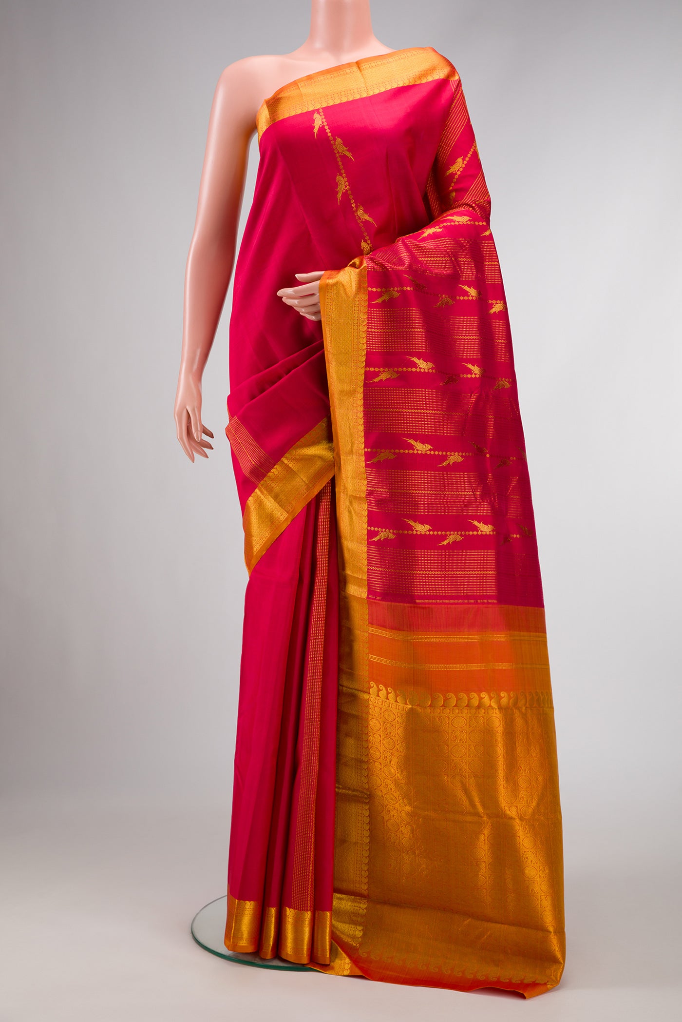 Dark Pink Dual Tone Kanjivaram Silk Saree with Stripes on the body and Zari Border.  displayed on a mannequin