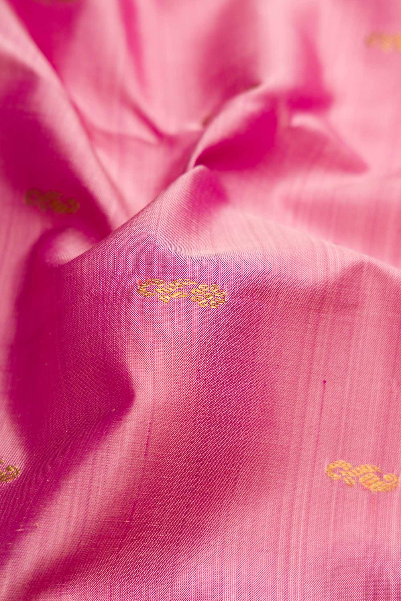 Close up of Pink Dual Tone Kanjivaram Silk Saree with Zari Butta on the body and Zari Border.  displaying folds