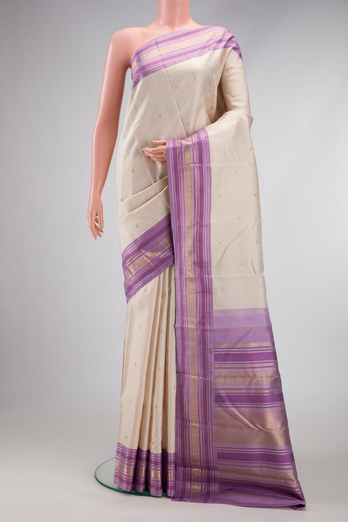 Pure Silk Pure Zari Off White Kanjivaram Saree with Checked design on the body and Zari And Thread Border.  displayed on a mannequin