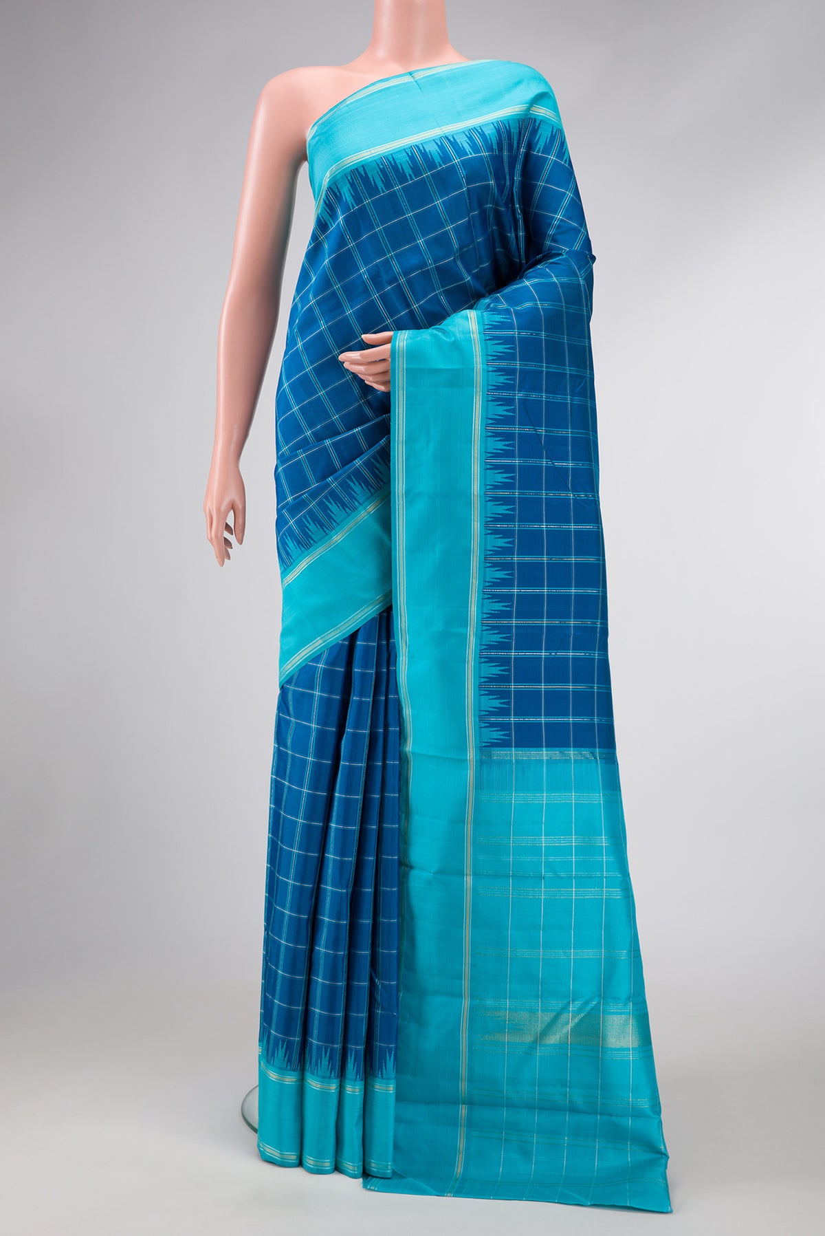Pure Silk Pure Zari Peacock Blue Dual Tone Kanjivaram Saree with Checked design on the body and Zari Border.  displayed on a mannequin