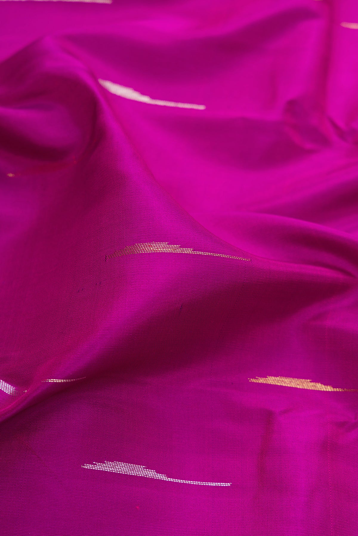 Close up of Pure Silk Pure Zari Purple Kanjivaram Saree with Zari Butta on the body and Fancy Border.  displaying folds