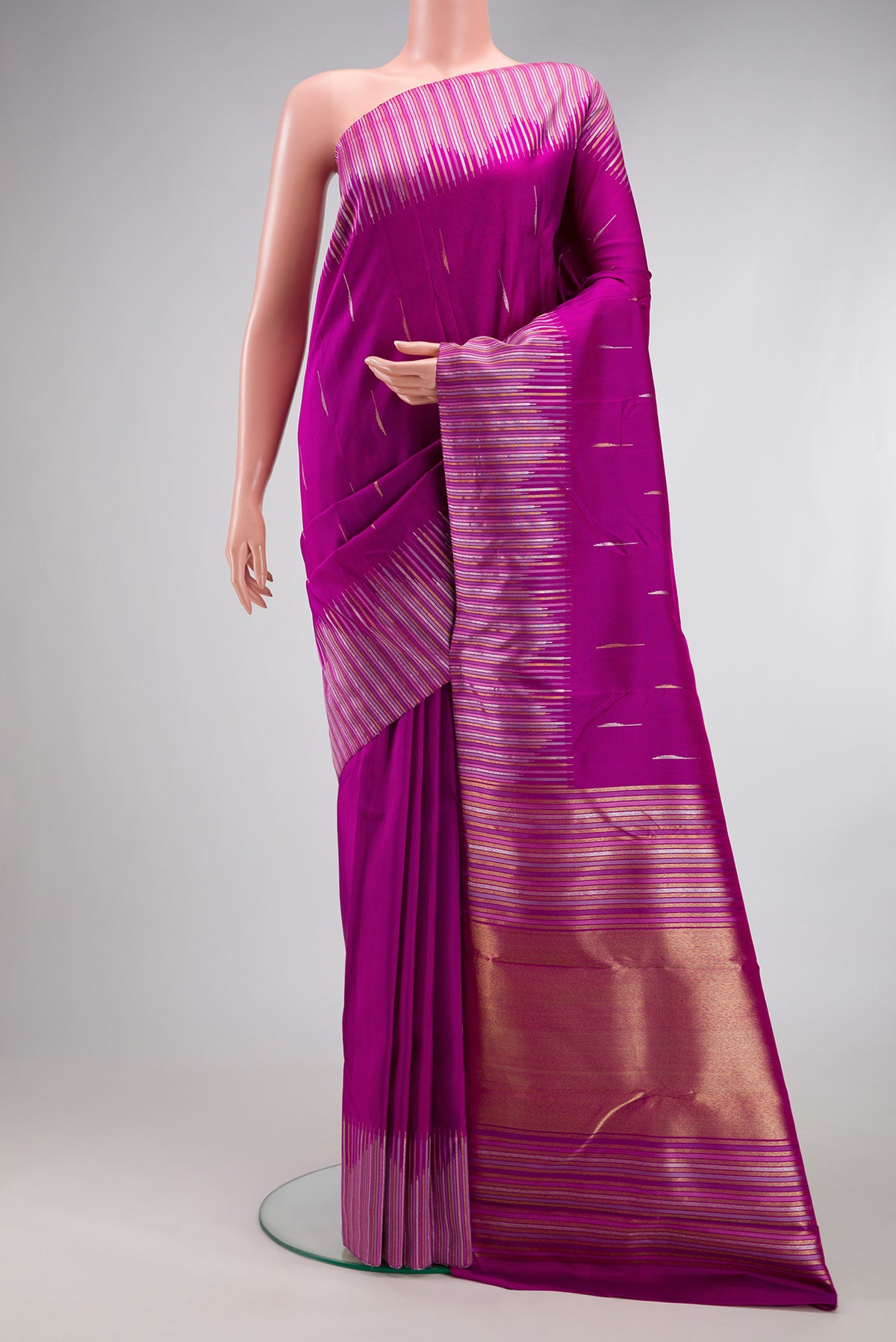 Pure Silk Pure Zari Purple Kanjivaram Saree with Zari Butta on the body and Fancy Border.  displayed on a mannequin